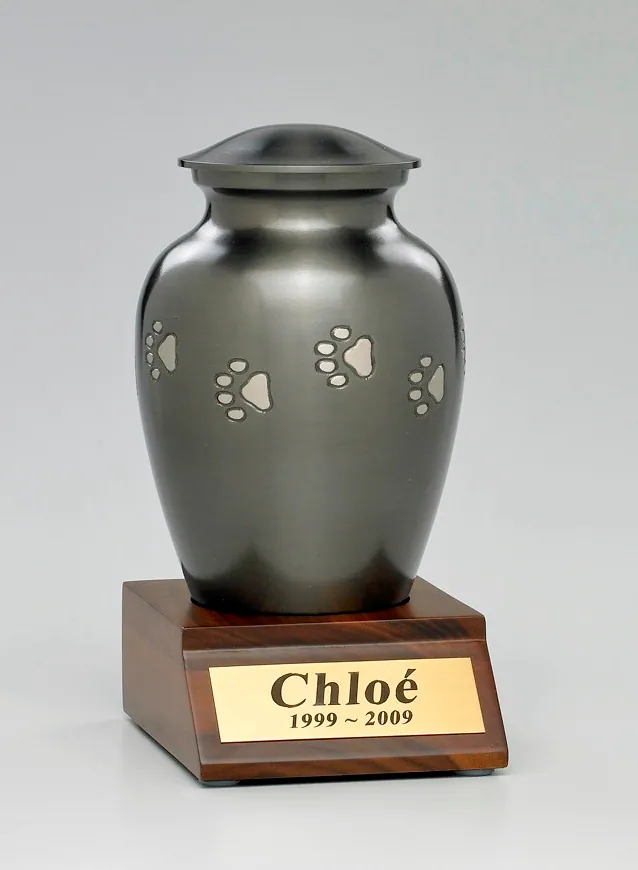 Paw print vase urn resting on a solid walnut base with a nameplate