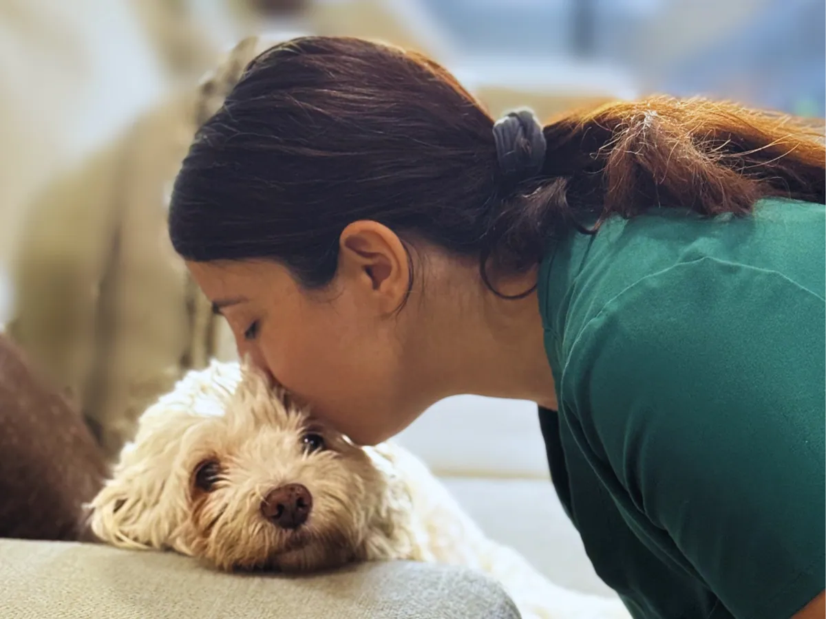 A veterinarian from Saving Grace Veterinary Services gently caring for a pet at home